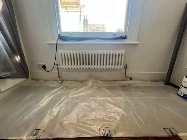 Column radiator installation below window