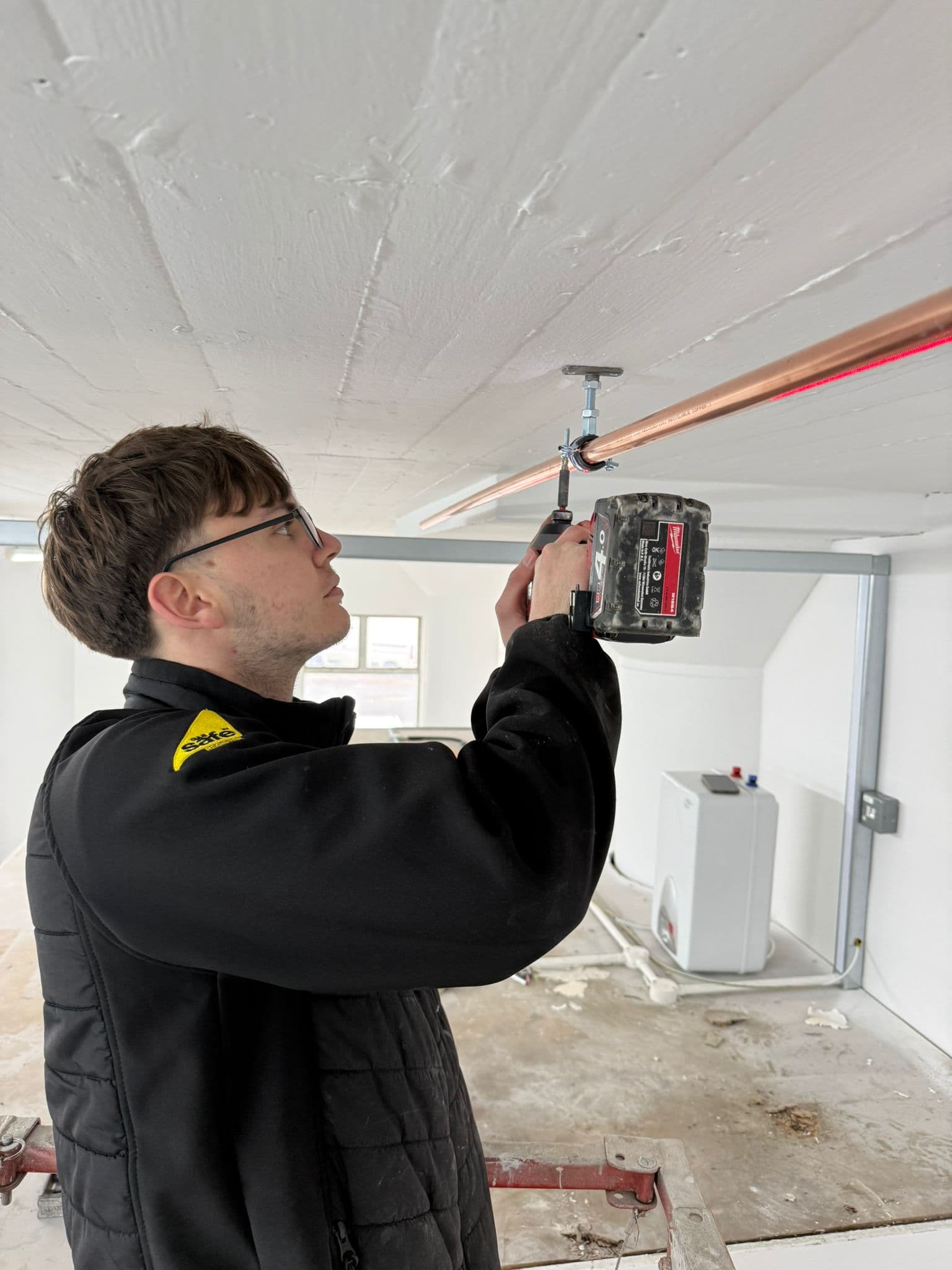 Apprentice engineer fitting copper pipework